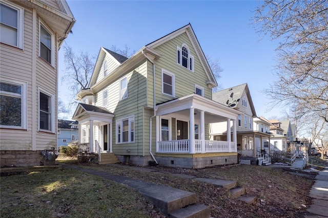 view of side of home with covered porch and entry steps