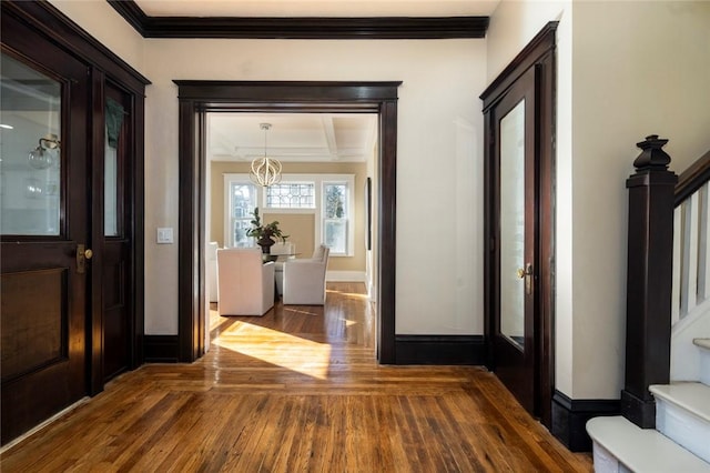 entryway featuring ornamental molding, stairs, baseboards, and dark wood-style flooring