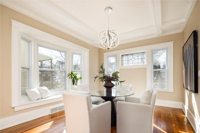 dining area with visible vents, baseboards, beamed ceiling, an inviting chandelier, and wood finished floors