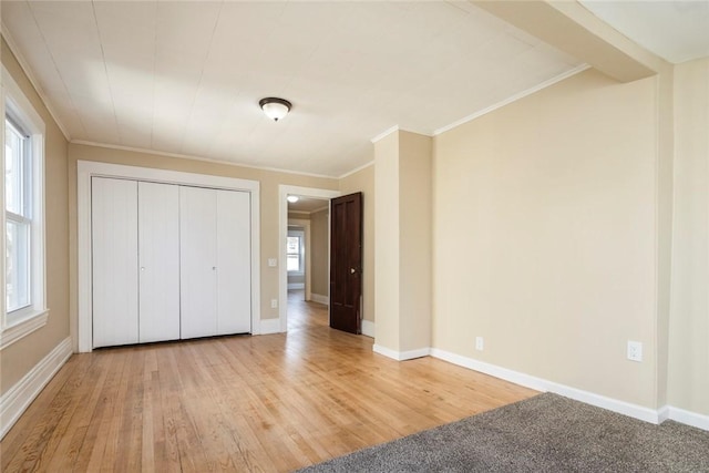 unfurnished bedroom with multiple windows and light wood-style flooring