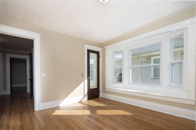 foyer with wood finished floors and baseboards