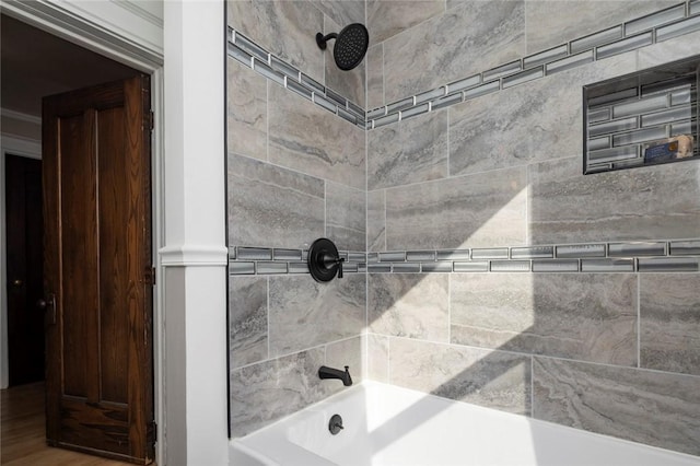 interior details with shower / bathing tub combination and wood finished floors