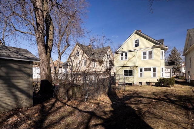 rear view of house with fence