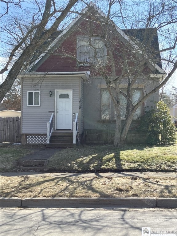 view of front of home featuring entry steps and fence