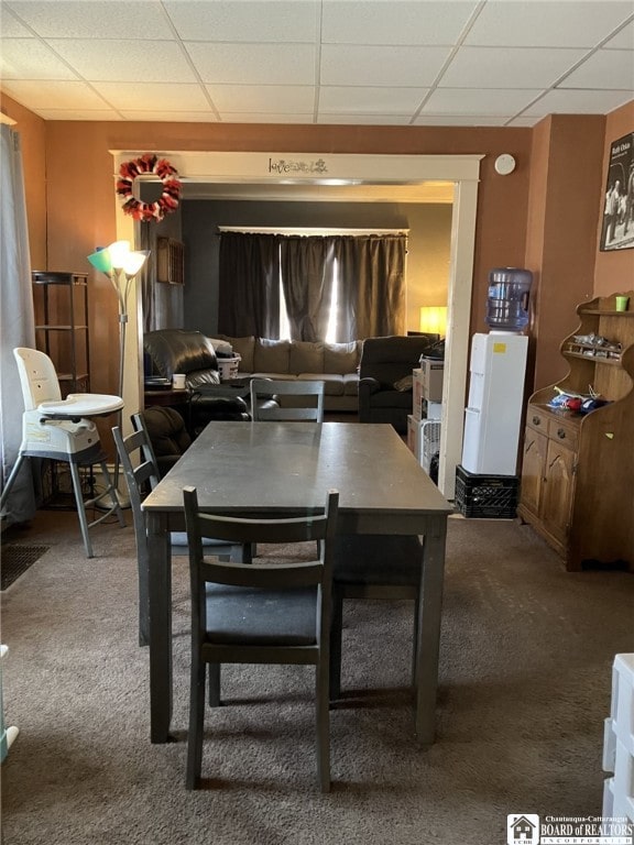 dining room with carpet flooring and a paneled ceiling