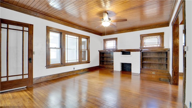 unfurnished living room with wooden ceiling, a brick fireplace, wood finished floors, and ornamental molding