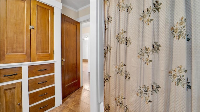 bathroom featuring tile patterned floors and ornamental molding