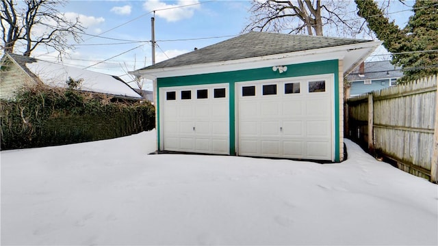 detached garage featuring fence