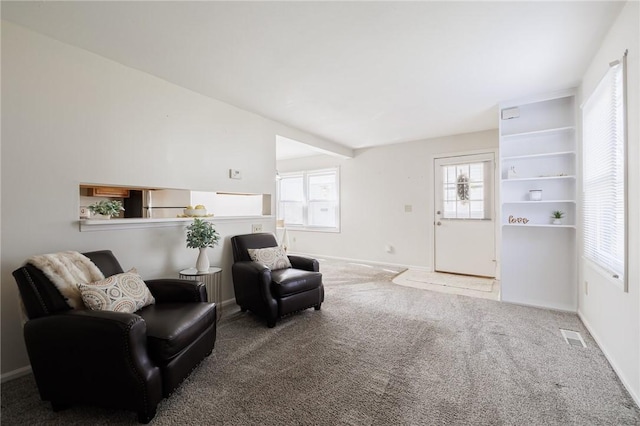 sitting room with carpet flooring, visible vents, and baseboards