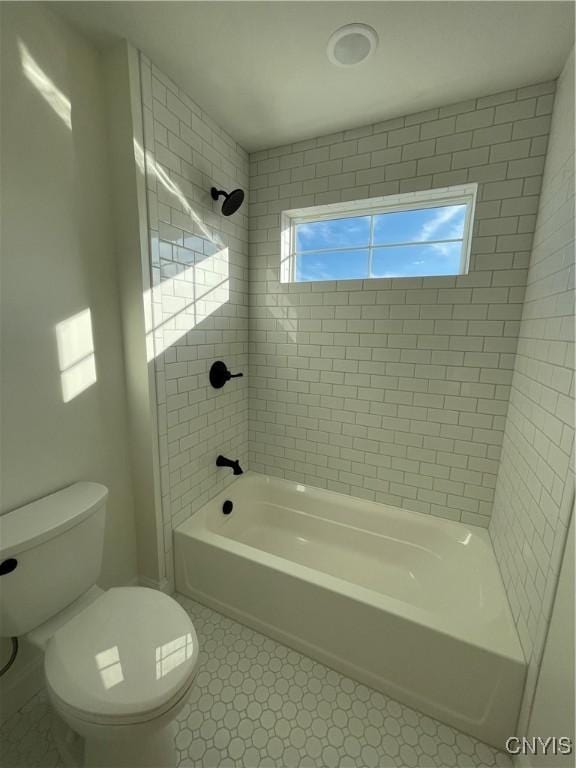 full bathroom featuring tile patterned floors, toilet, and washtub / shower combination
