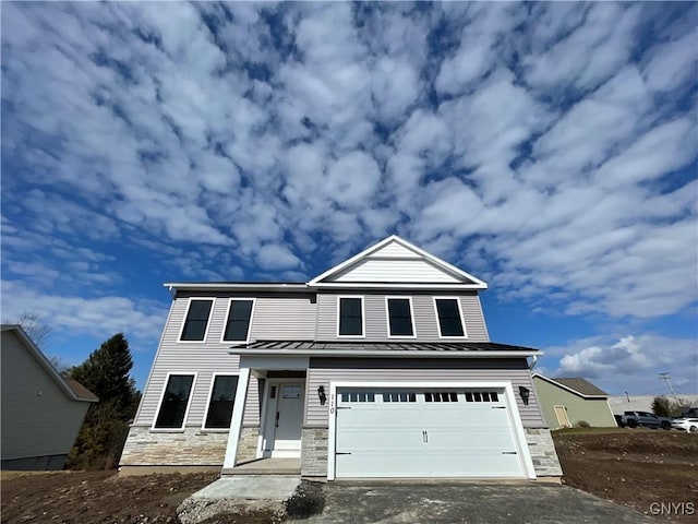 view of front of property featuring driveway, a standing seam roof, a garage, stone siding, and metal roof