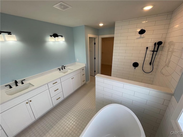 full bathroom featuring a soaking tub, visible vents, a tile shower, and a sink