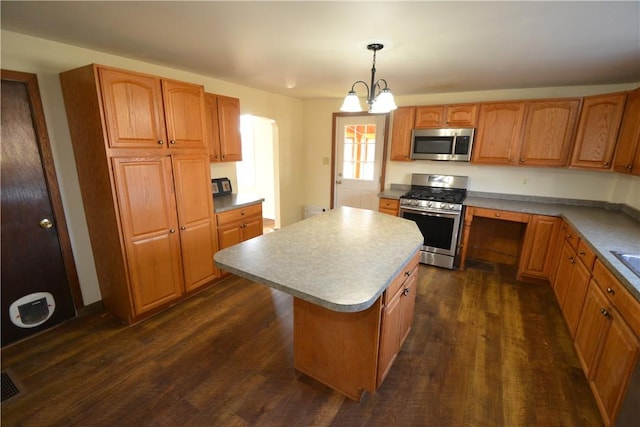 kitchen with a center island, brown cabinetry, dark wood-style flooring, and stainless steel appliances