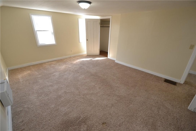 unfurnished bedroom with a closet, visible vents, baseboards, and carpet floors