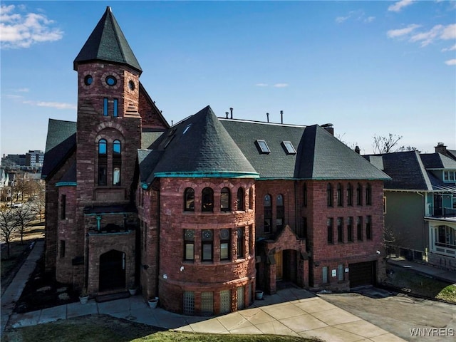 233 Richmond Ave Unit 15, Buffalo, NY 14222 - exterior space featuring driveway, an attached garage, and brick siding
