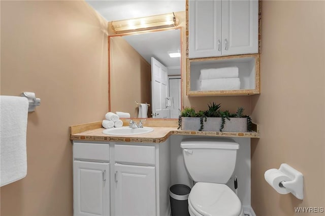 bathroom with toilet and vanity