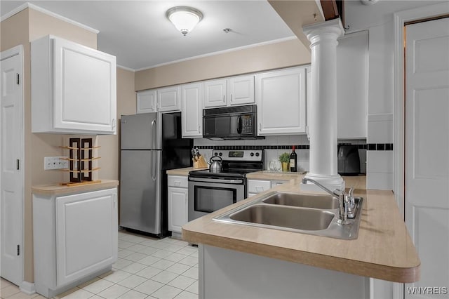 kitchen featuring ornate columns, a sink, stainless steel appliances, crown molding, and tasteful backsplash