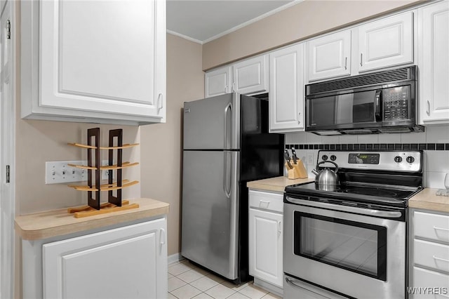 kitchen featuring backsplash, appliances with stainless steel finishes, and white cabinets