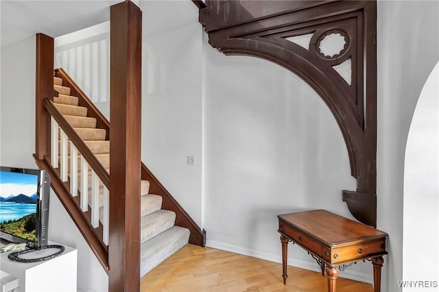 staircase featuring wood finished floors