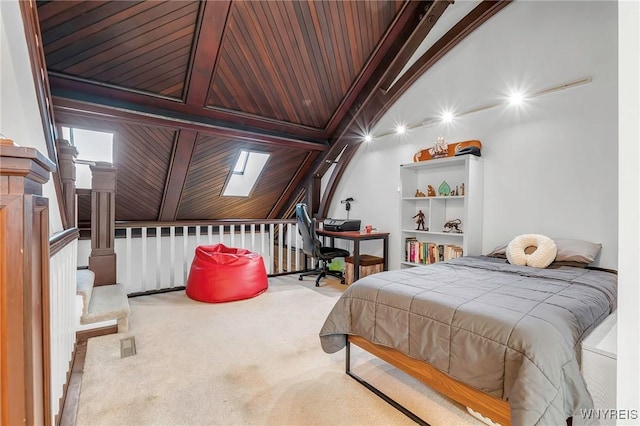 bedroom with carpet flooring, vaulted ceiling with skylight, and wood ceiling