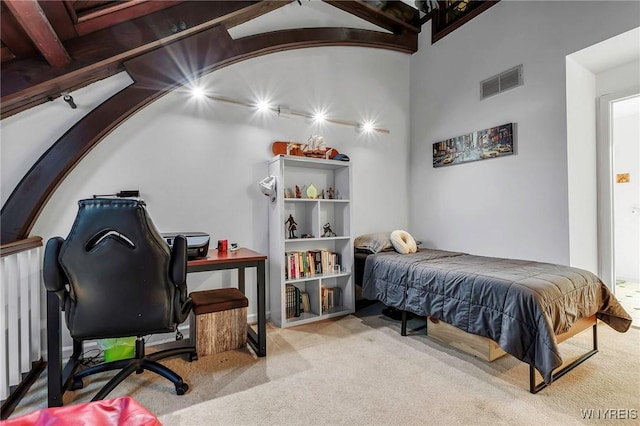 carpeted bedroom featuring visible vents