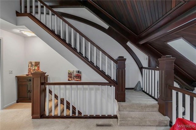 staircase featuring visible vents, baseboards, and carpet