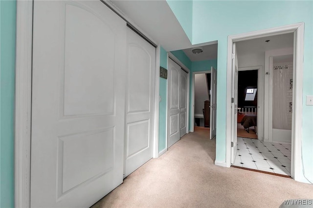 hallway with light colored carpet