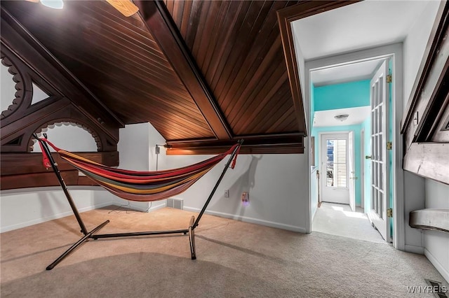 interior space with wooden ceiling, carpet, and baseboards