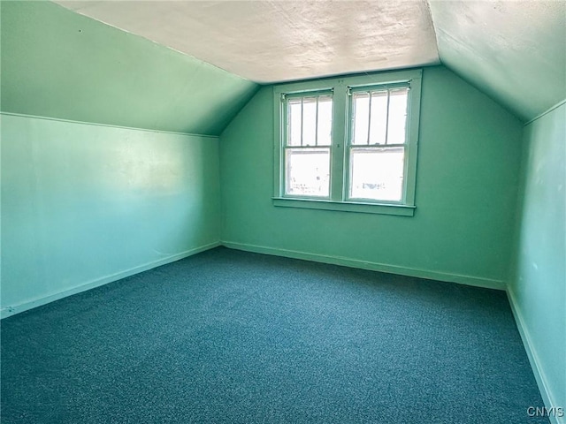 bonus room with baseboards, carpet floors, a textured ceiling, and lofted ceiling