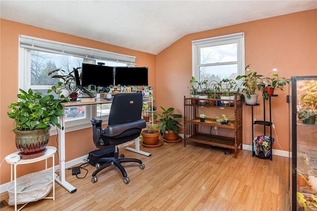 office area featuring baseboards, lofted ceiling, and wood finished floors