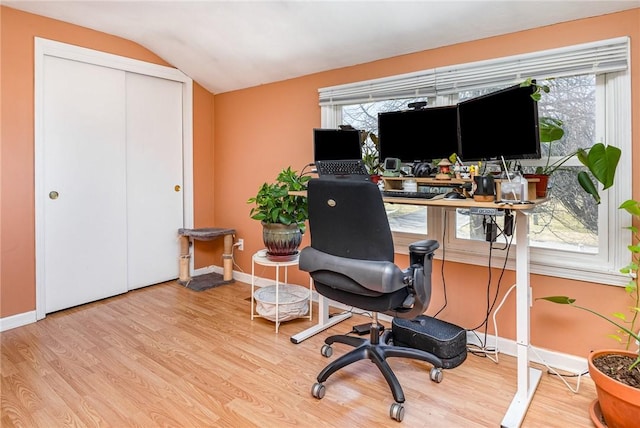 office area with lofted ceiling, wood finished floors, and a wealth of natural light