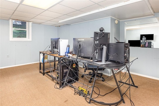 office space with carpet, a paneled ceiling, and baseboards