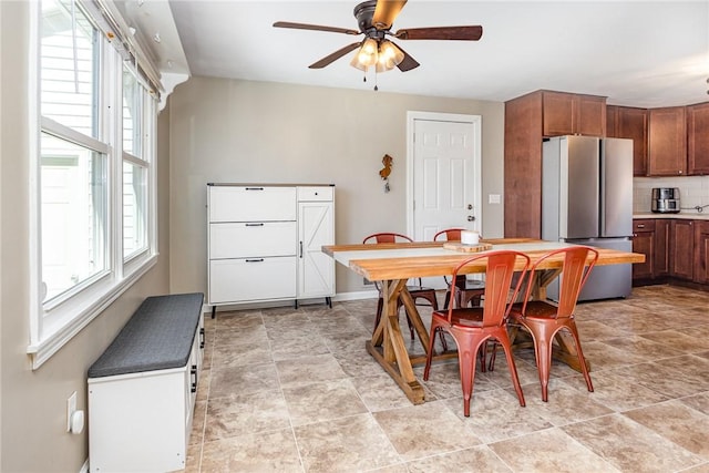 dining area with baseboards and ceiling fan