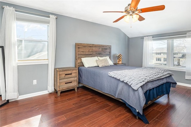 bedroom with dark wood finished floors, vaulted ceiling, a ceiling fan, and baseboards