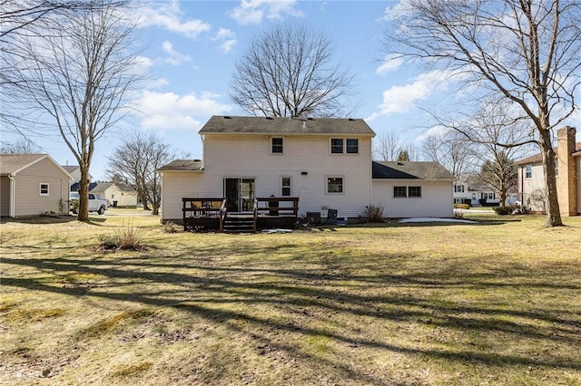 back of property featuring a yard and a wooden deck