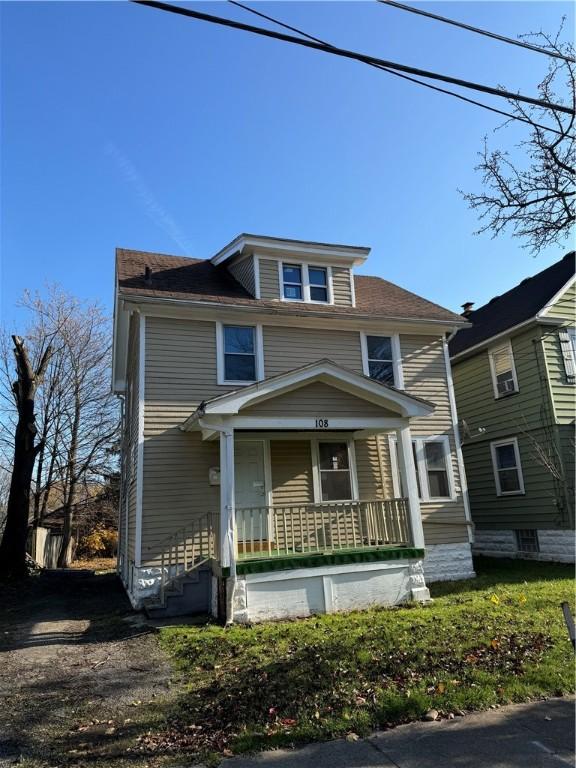 american foursquare style home with covered porch