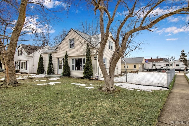 view of front of property with a front lawn, fence, and a residential view