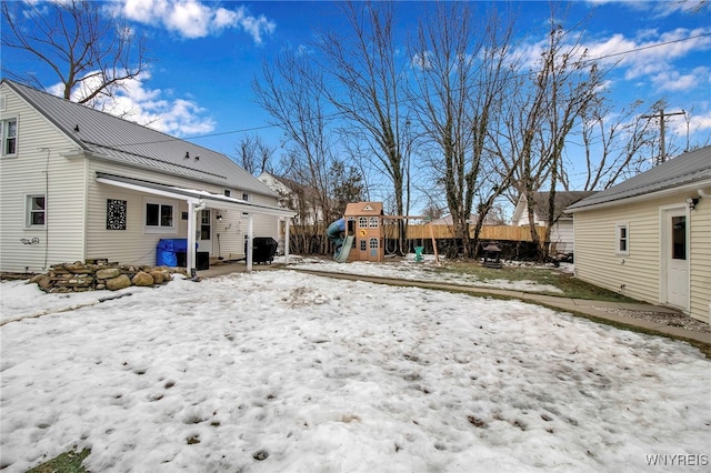 exterior space with a playground and fence