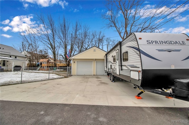 detached garage featuring fence