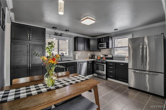 kitchen featuring a wealth of natural light, stainless steel appliances, and ornamental molding