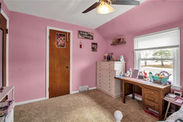 carpeted office featuring lofted ceiling, baseboards, visible vents, and ceiling fan