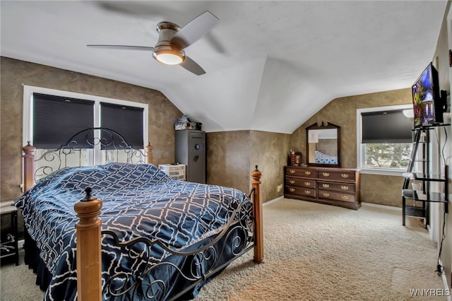 carpeted bedroom with a ceiling fan and vaulted ceiling