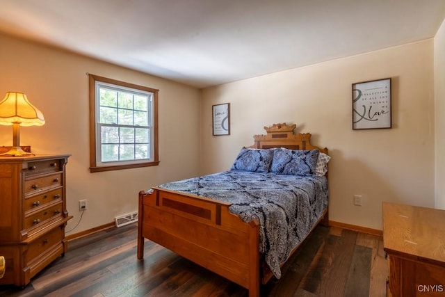 bedroom with dark wood-type flooring, visible vents, and baseboards