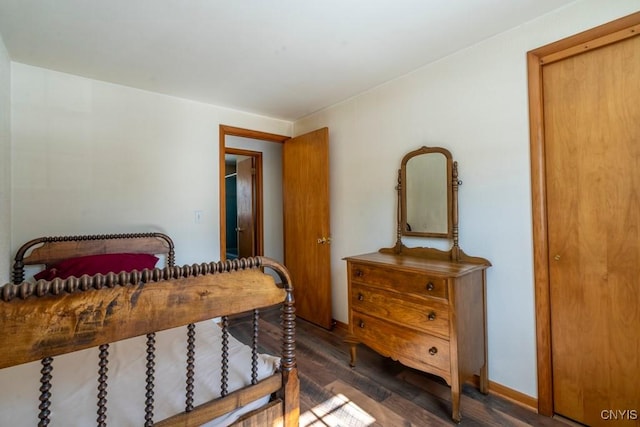 bedroom with wood finished floors and baseboards