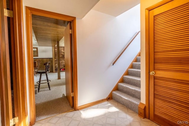 stairs featuring baseboards and carpet floors