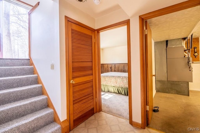 stairs featuring tile patterned floors, baseboards, carpet, and a healthy amount of sunlight