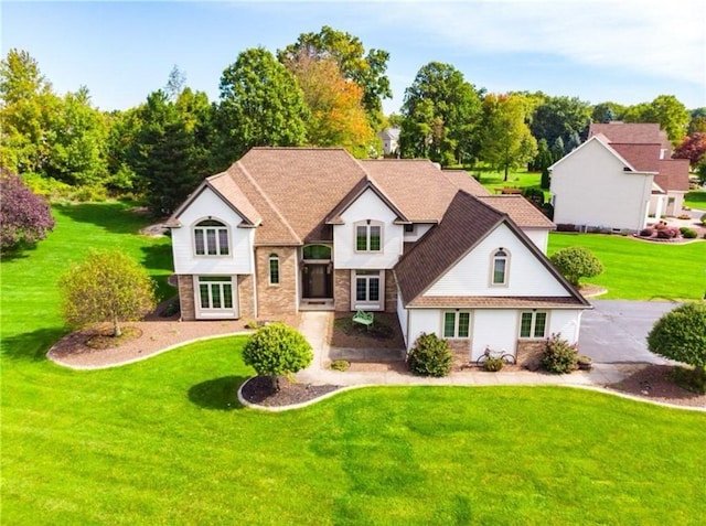 bi-level home with a front lawn