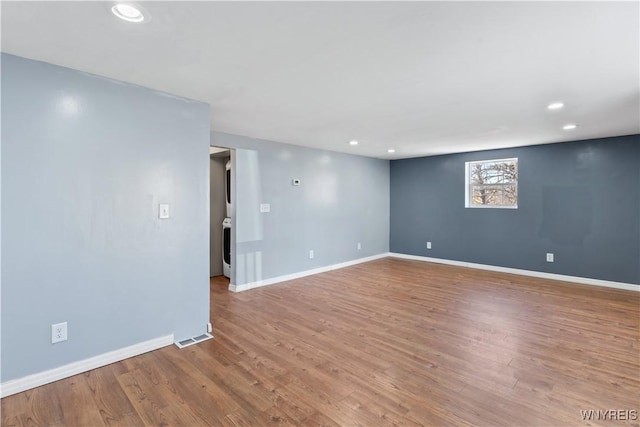 spare room featuring recessed lighting, visible vents, baseboards, and wood finished floors