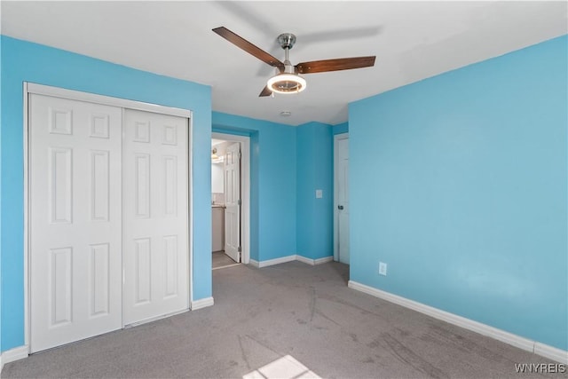 unfurnished bedroom with a closet, baseboards, carpet, and ceiling fan