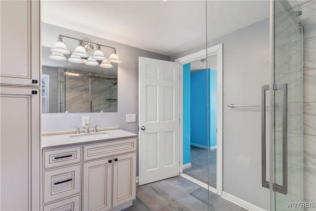 full bath featuring vanity, a shower stall, and baseboards